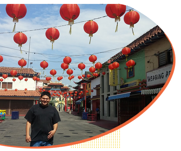 D.E.S.I. client exploring Chinatown, Los Angeles with his educator as part of a regional center service.